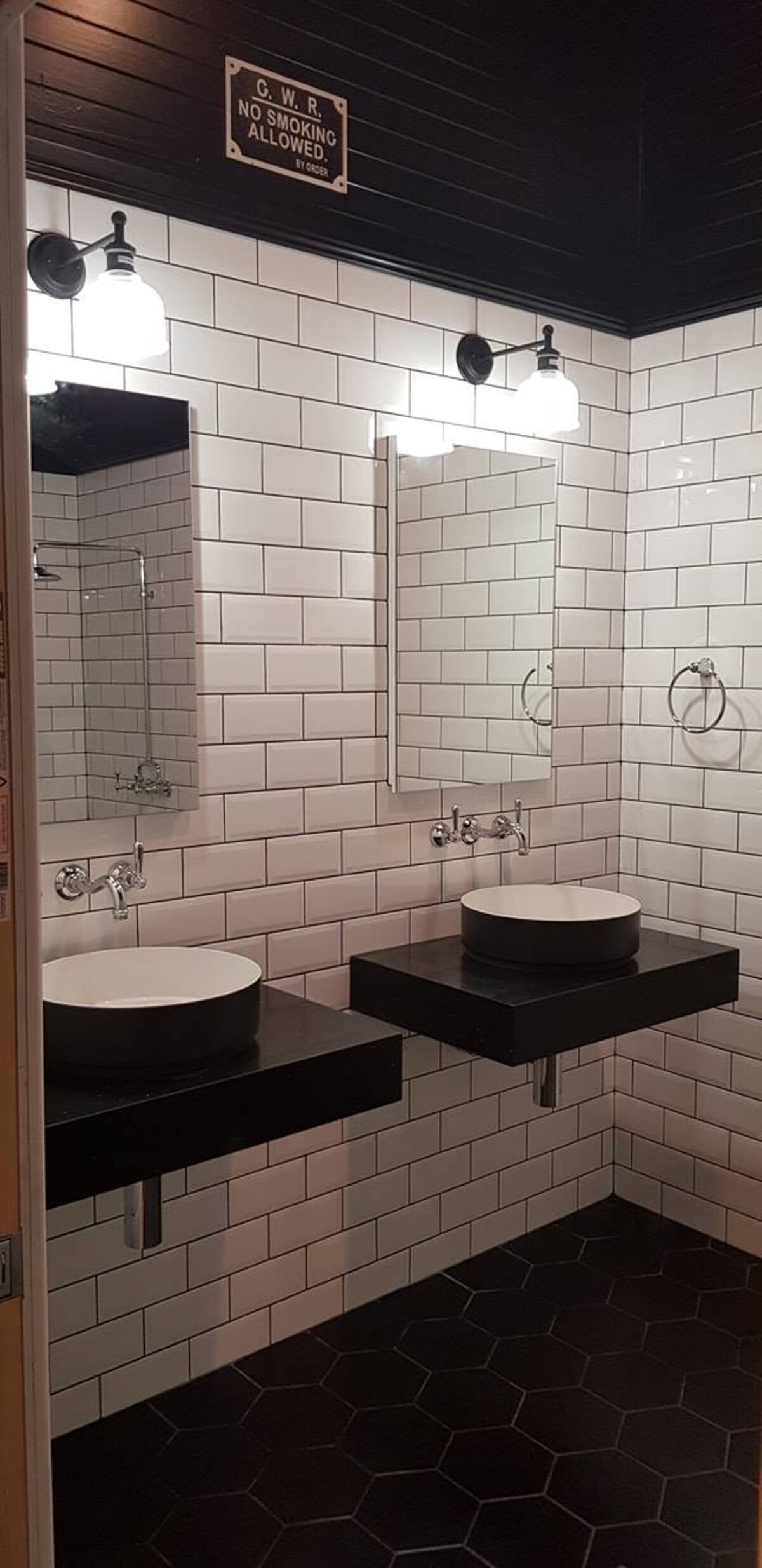 Completed bathroom with hexagon floor tile and twin basins