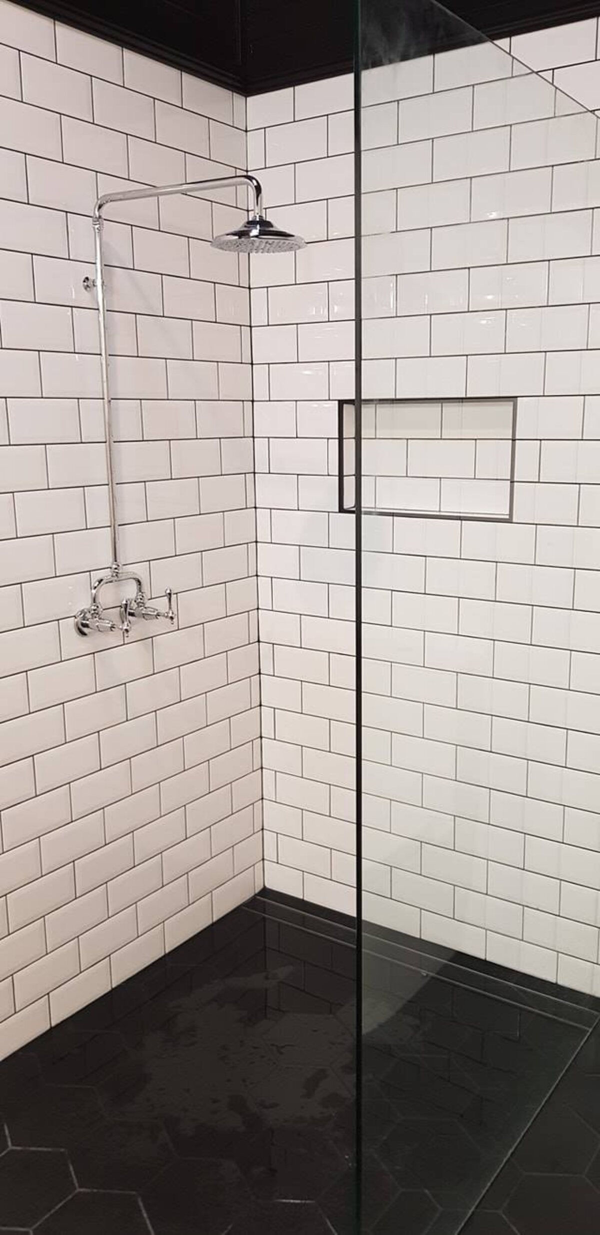 Subway tiled shower with frameless screen